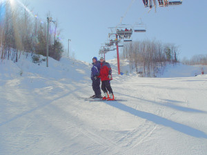 Cascad skier with volunteer